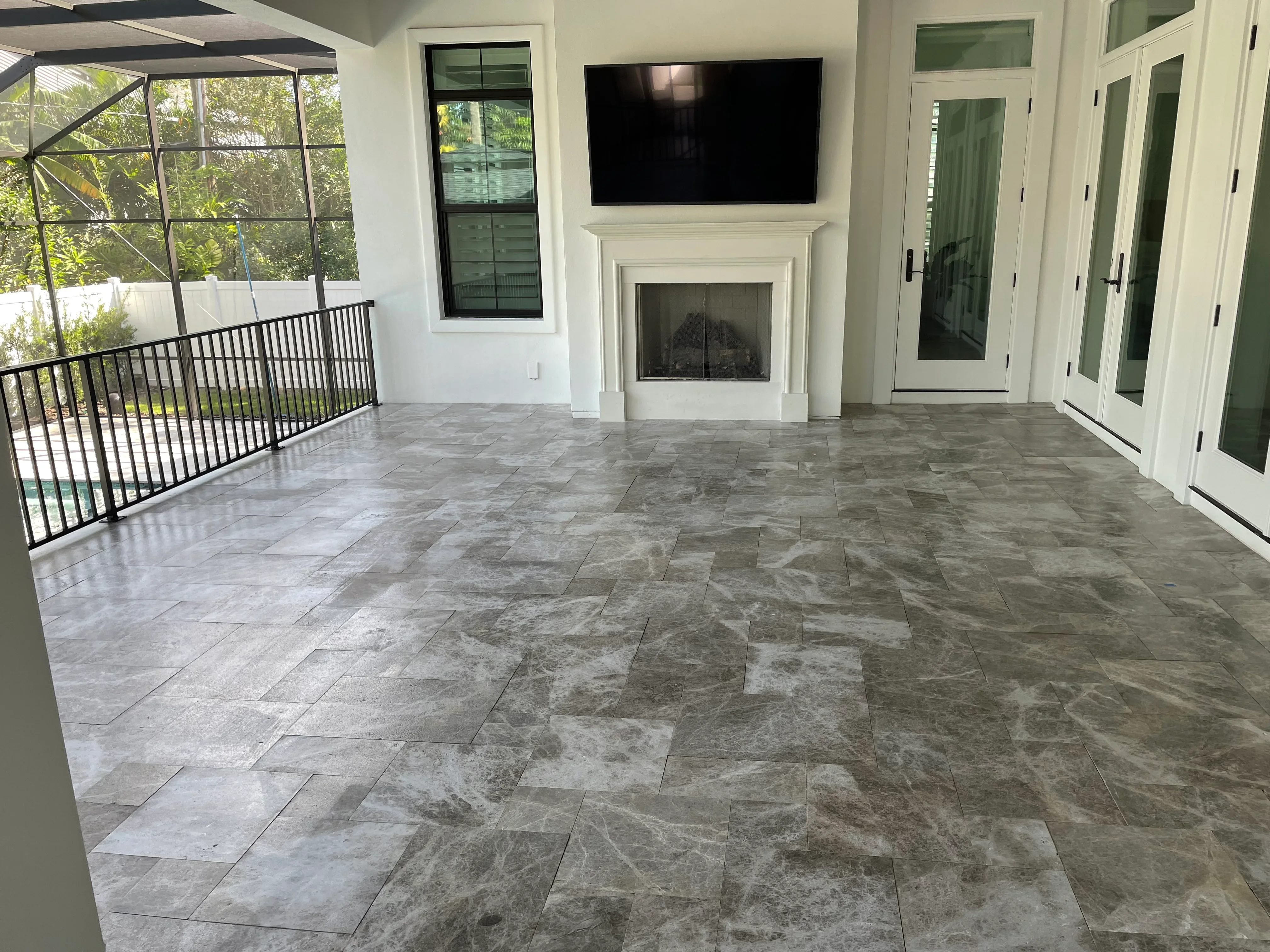 Sealed porcelain paver patio with running bond pattern and grout lines