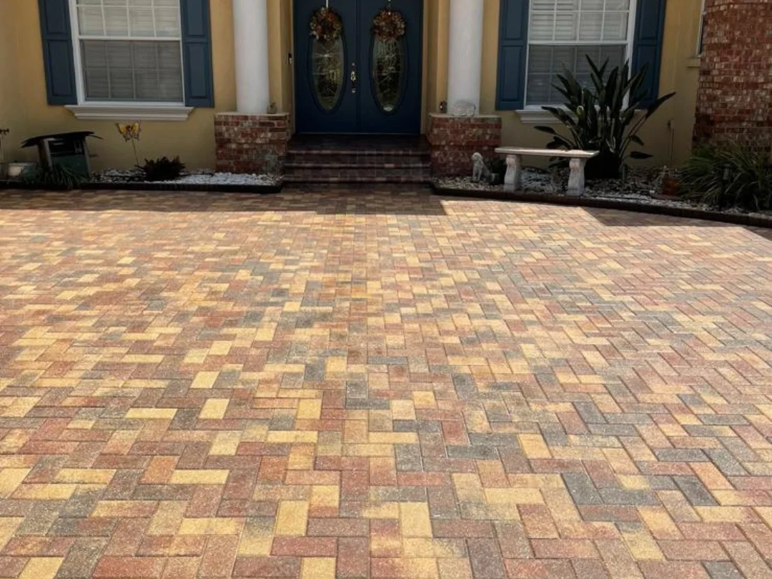 Sealed clay brick paver driveway in herringbone pattern with warm earth tones