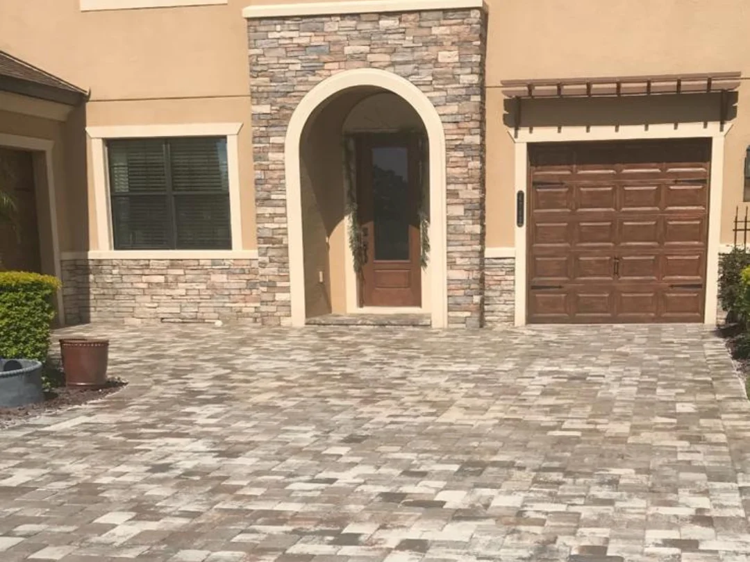 Sealed stone paver driveway with geometric pattern in gray and neutral tones