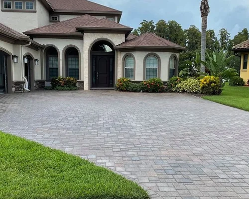 Sealed gray permeable pavers on large residential driveway with enhanced color and protective finish